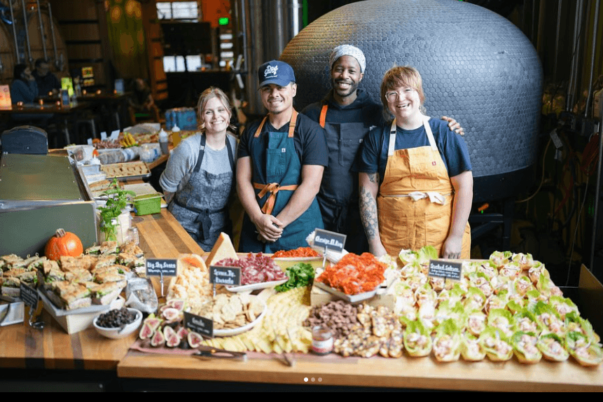 Fromagio's catering staff with a gorgeous buffet spread.